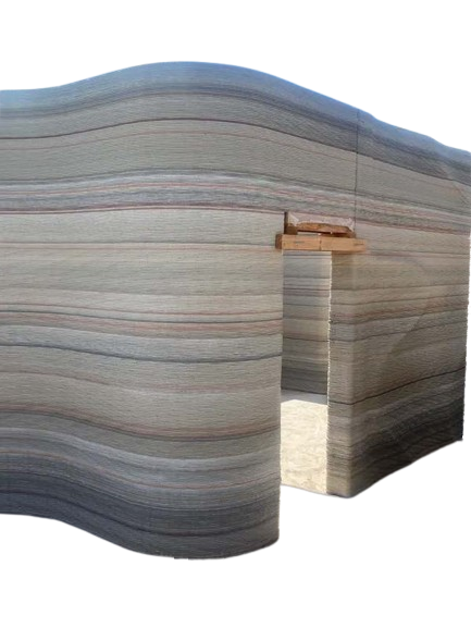 Exterior of multi-colored 3D printed wall of a custom home mid-build.