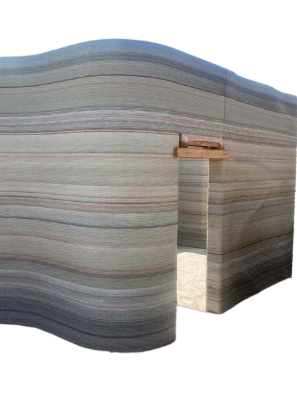 Exterior of multi-colored 3D printed wall of a custom home mid-build.