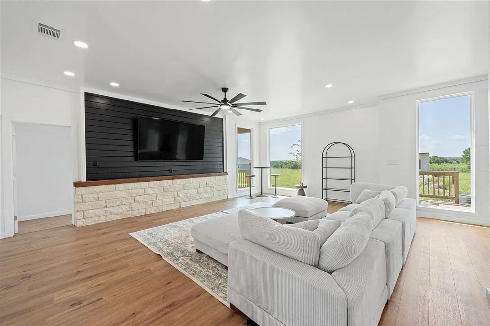 Living room of a custom built 3D printed modern home with a large TV and couch
