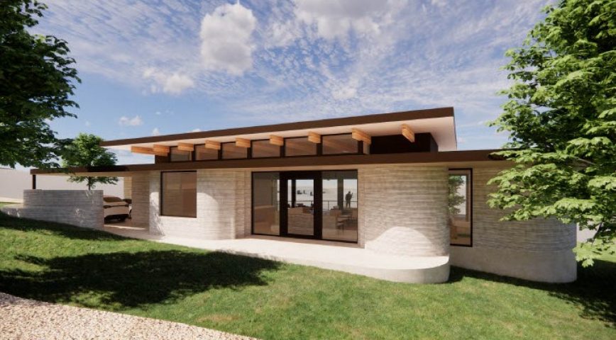 Exterior of custom built 3D printed home with large windows and modern architecture